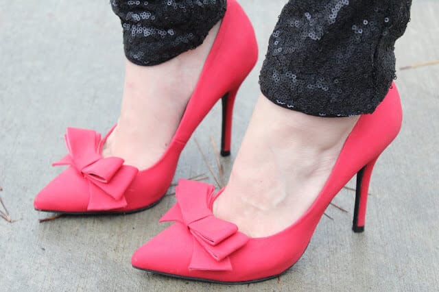Red bow heels, black sequin pants